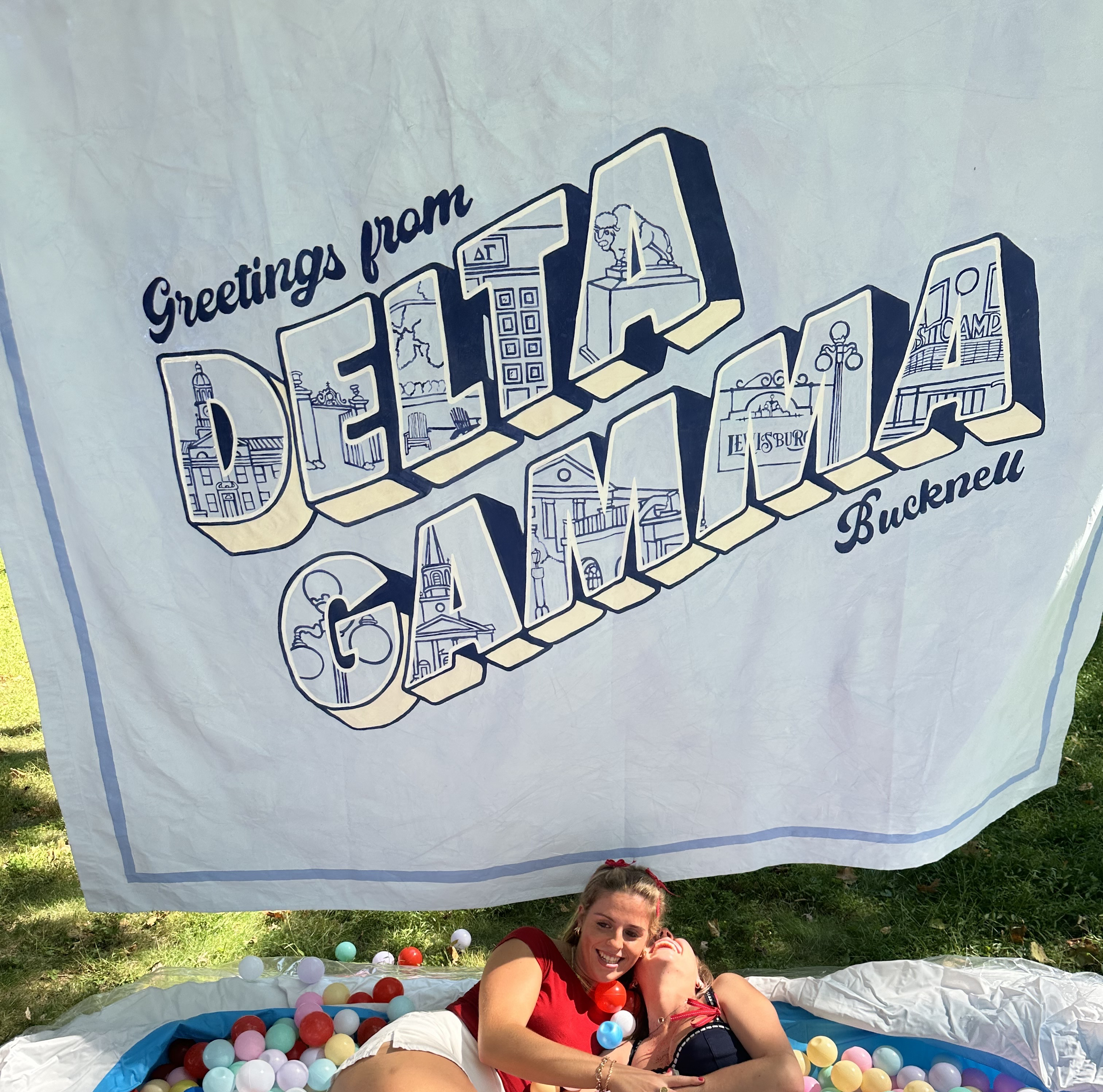 two people in frount of a banner that says Delta Gamma